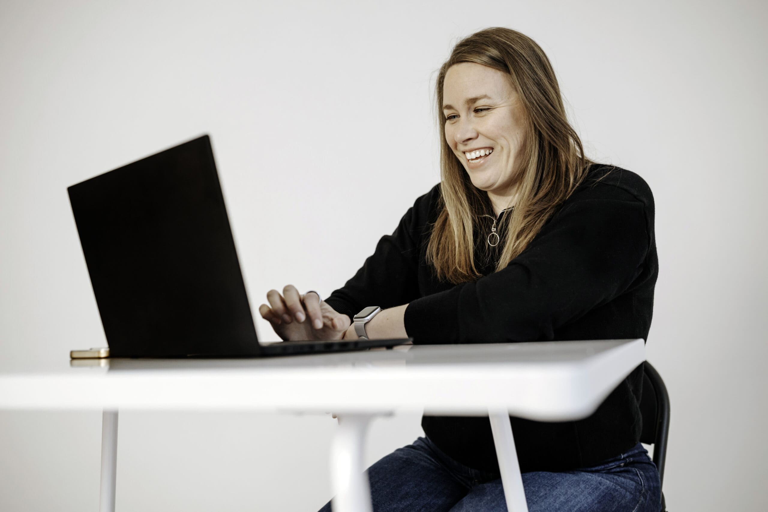 Woman smiling looking into computer screen