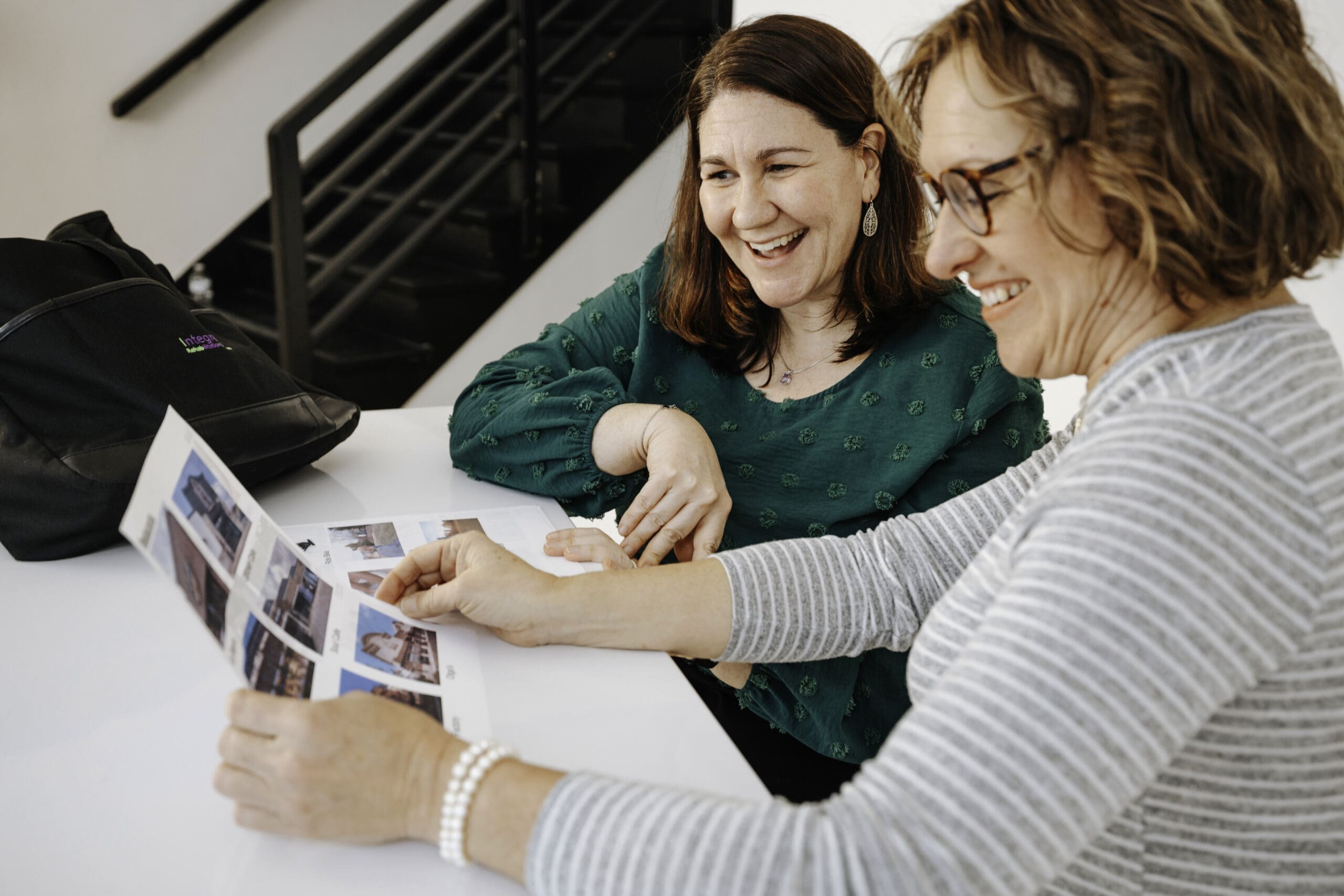 Speech therapist working with patient while looking at a sheet of photos